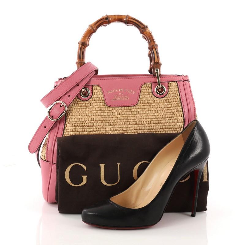 This authentic Gucci Bamboo Shopper Tote Straw Small mixes classic Gucci styling with romance. Crafted from brown straw and pink leather, this simple yet stylish tote features Gucci's signature sturdy bamboo handles, protective base studs, and
