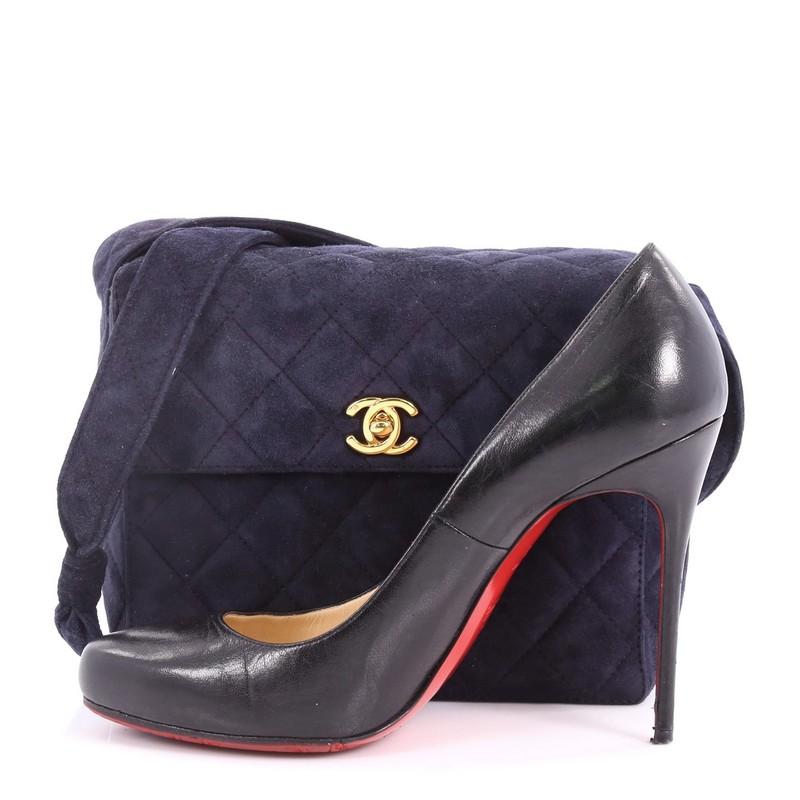 This authentic Chanel Vintage Top Handle Flap Bag Quilted Suede Small showcases a timeless design perfect for any woman. Crafted in navy blue diamond quilted suede, this bag features a single looped top handle, front flap with CC turn-lock closure