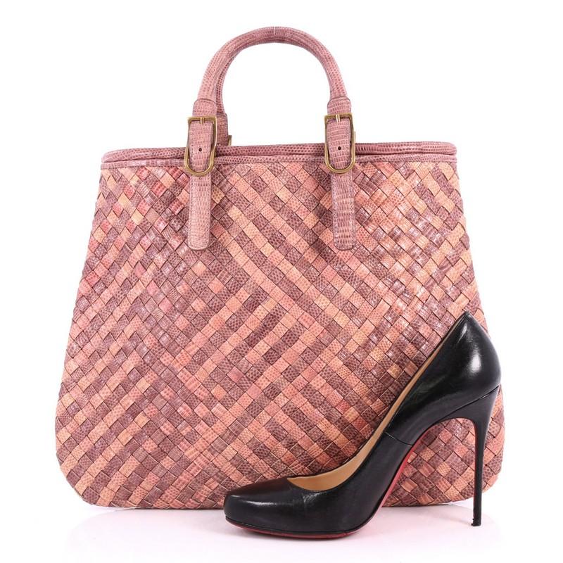 This authentic Bottega Veneta Belted Tote Intrecciato Karung Large is a statement piece perfect for your daily excursions. Crafted in genuine pink and purple Karung snakeskin in Bottega Veneta's signature intrecciato woven method, this oversized