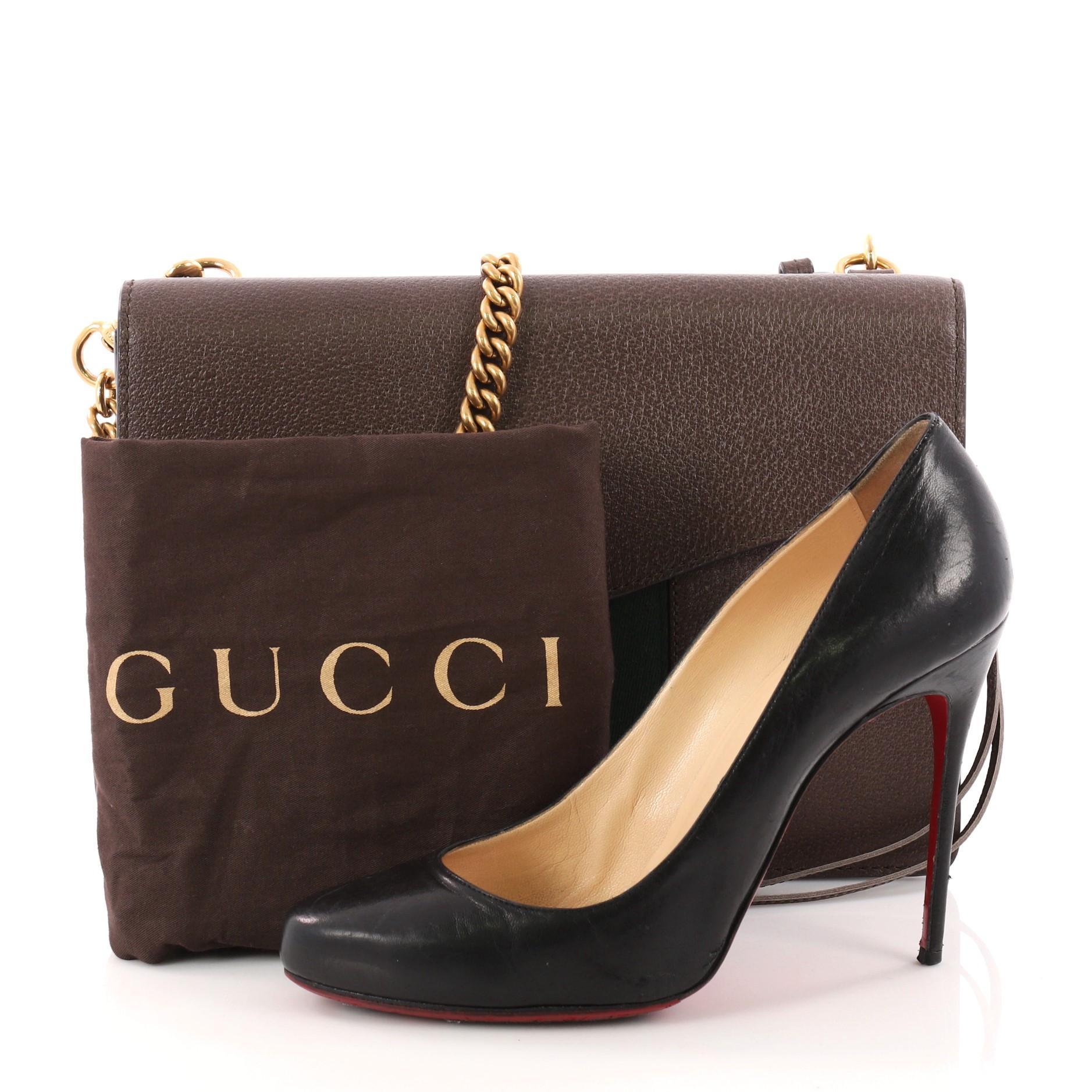 This authentic Gucci Animalier Web Chain Shoulder Bag Leather Small is a chic bag perfect for on-the-go fashionistas. Crafted in brown leather, this shoulder bag features chain-link shoulder strap, red and green wed detailing, gold-tone feline head