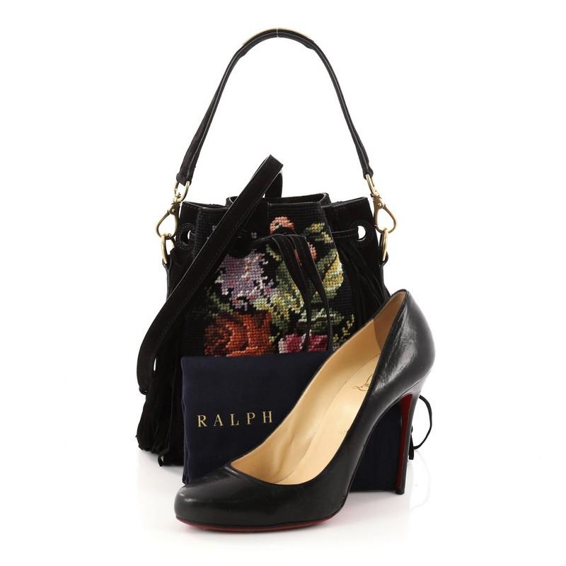 This authentic Ralph Lauren Collection Drawstring Bucket Bag Embroidered Wool with Fringe Small is a stylish and fun bag perfect for your everyday excursions. Crafted in black embroidered wool, this bucket bag features detachable flat top handle,