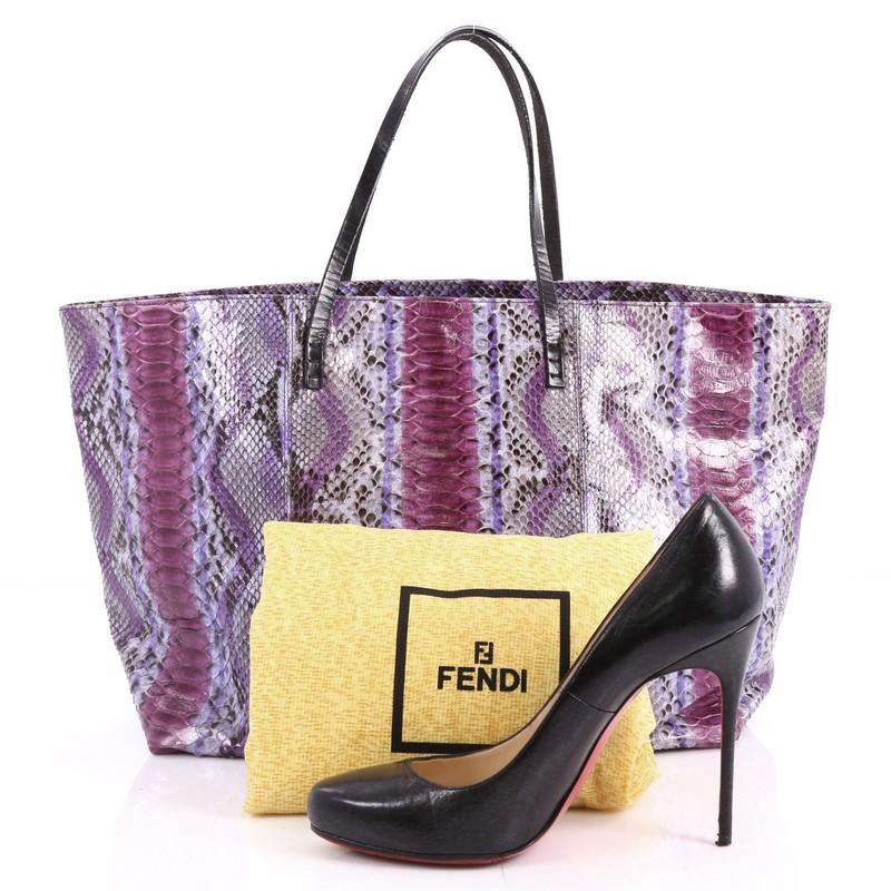 This authentic Fendi Matrioska Tote Python Large is unique and stylish in perfect for fashionistas. Crafted from genuine purple python skin, this tote features dual tall flat handles, and silver-tone hardware accents. It opens to a purple