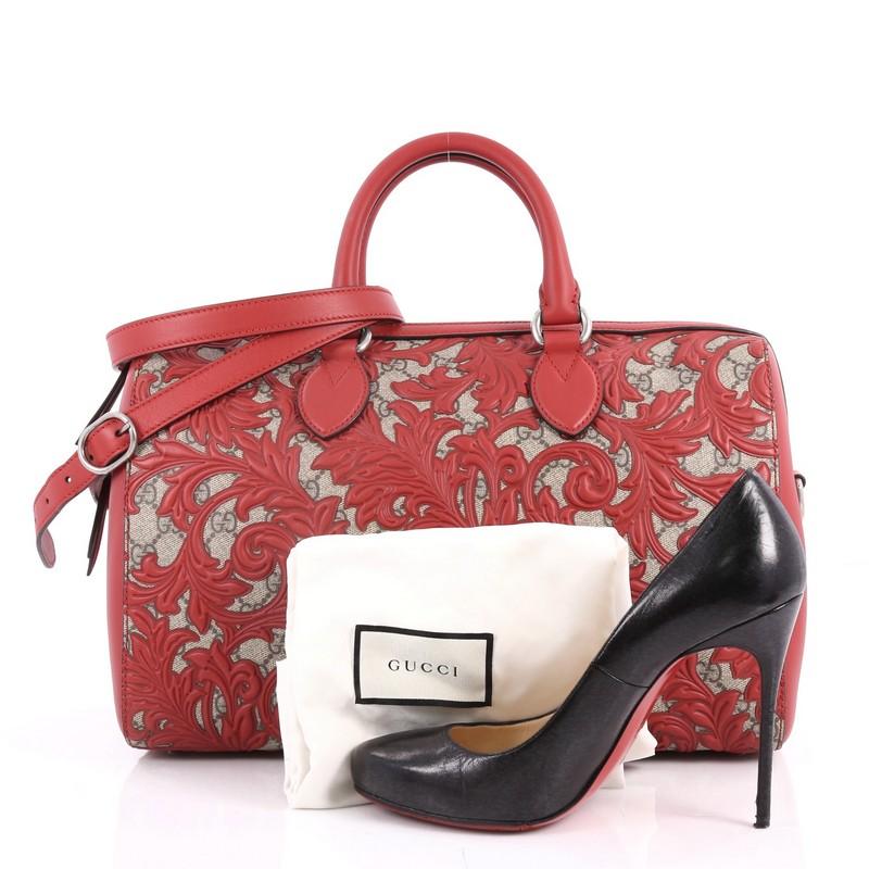 This authentic Gucci Convertible Boston Bag Arabesque GG Coated Canvas Medium is an easy to carry everyday bag that is both stylish and functional. Crafted from taupe GG monogram supreme coated canvas with an overlay of red leather floral Arabesque