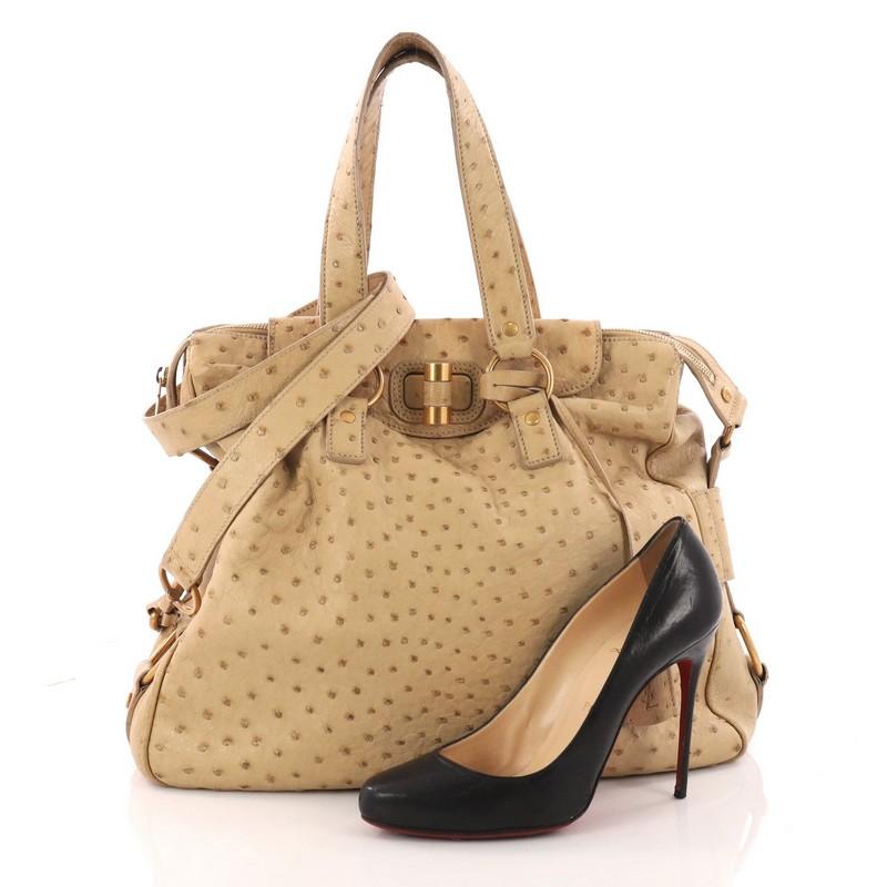 This authentic Saint Laurent Rive Gauche Satchel Ostrich Large combines the brand's sophisticated yet playful style. Crafted from genuine beige ostrich, this oversized satchel features dual-flat handles, twist-lock and zipper closure, protective