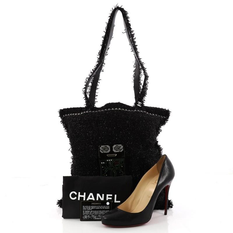 This authentic Chanel Shopping Tote Embellished Tweed Large from the brand's 2017 Data Center Collection is a chic tote with a timeless style for everyday use. Crafted in black embellished tweed, this bag features dual leather and tweed handles,