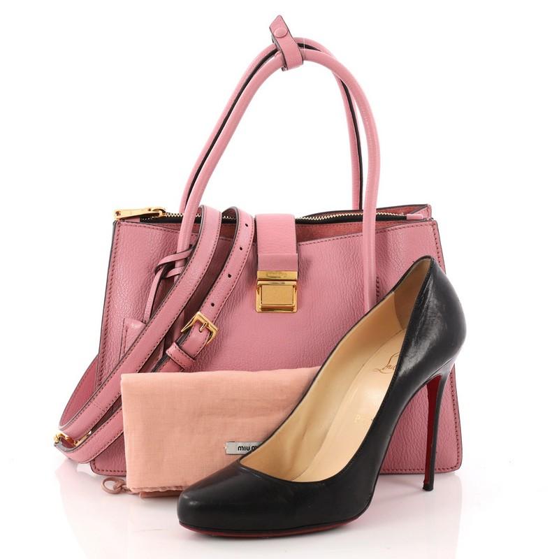 This authentic Miu Miu Madras Convertible Compartment Tote Leather Medium showcases a chic and stylish design perfect for everyday use. Crafted from pink leather, this sophisticated tote features dual-rolled handles, detachable shoulder strap,