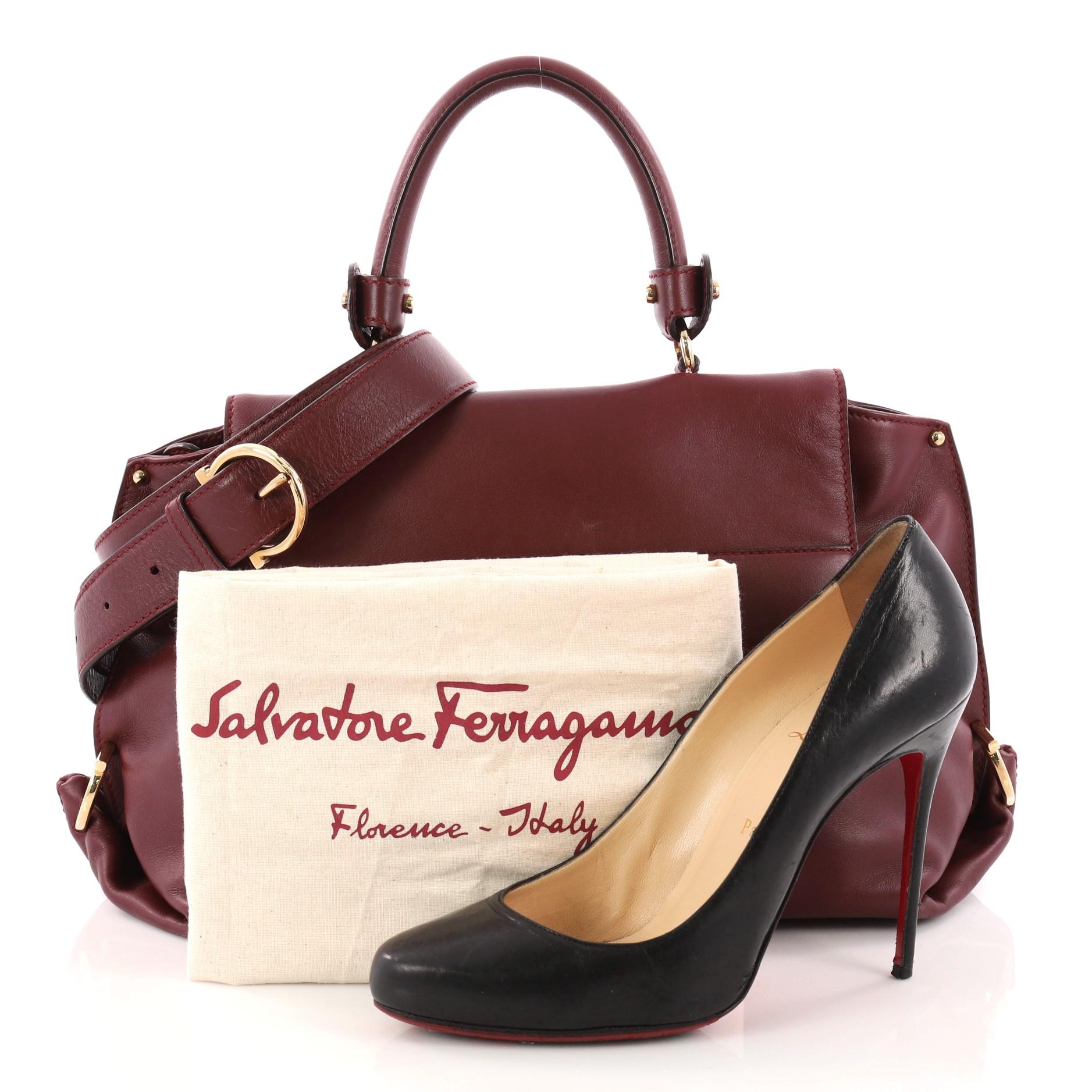 This authentic Salvatore Ferragamo Sofia Satchel Smooth Leather Medium is stylish and functional. Crafted in burgundy smooth leather, this bag features a sturdy top handle with exterior back zip pocket, and gold-tone hardware accents. The brand's