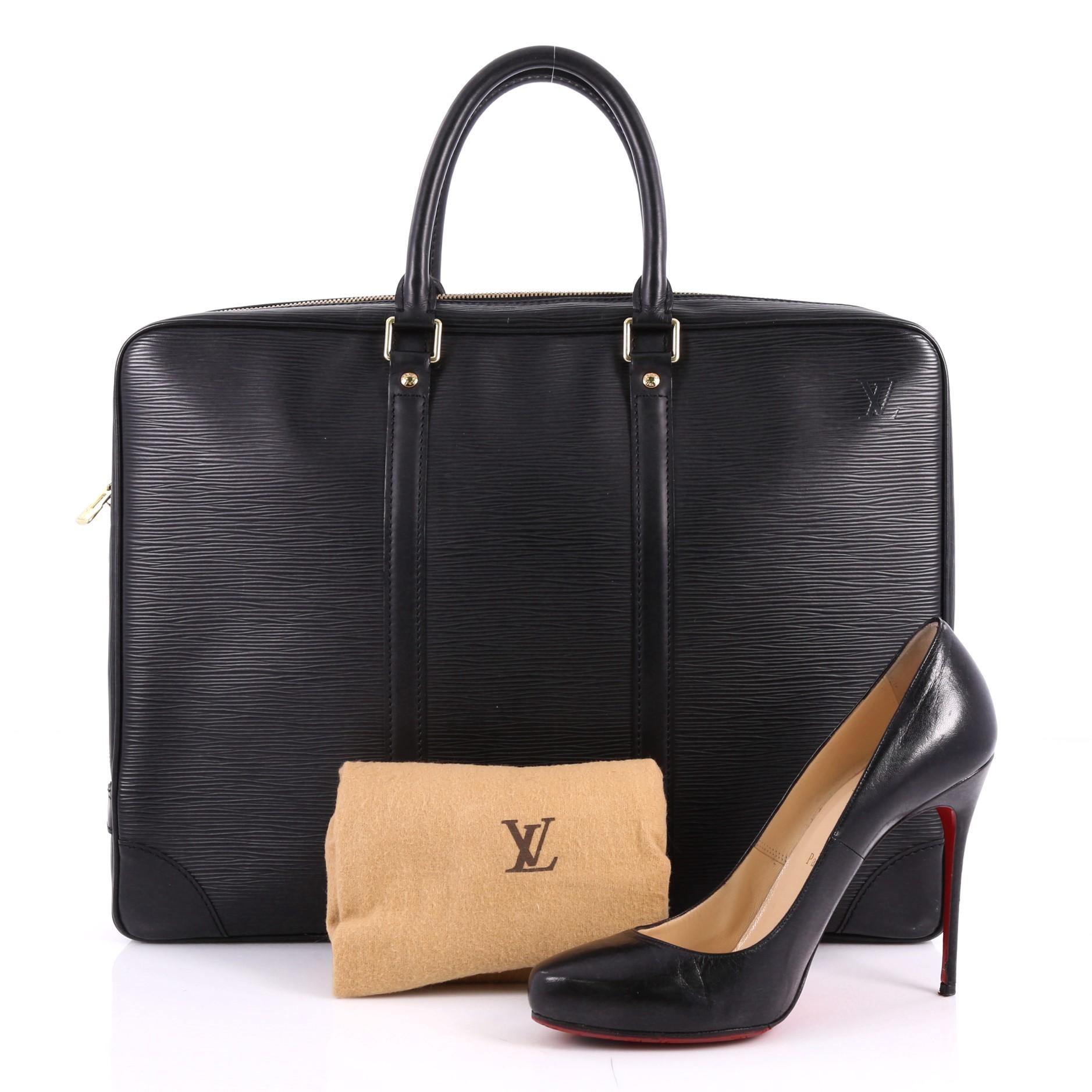 This authentic Louis Vuitton Porte-Documents Voyage Briefcase Epi Leather updates its traditional men's briefcase with a luxurious and urban spin. Crafted in black epi leather, this functional bag features a flat silhouette, dual-rolled handles,
