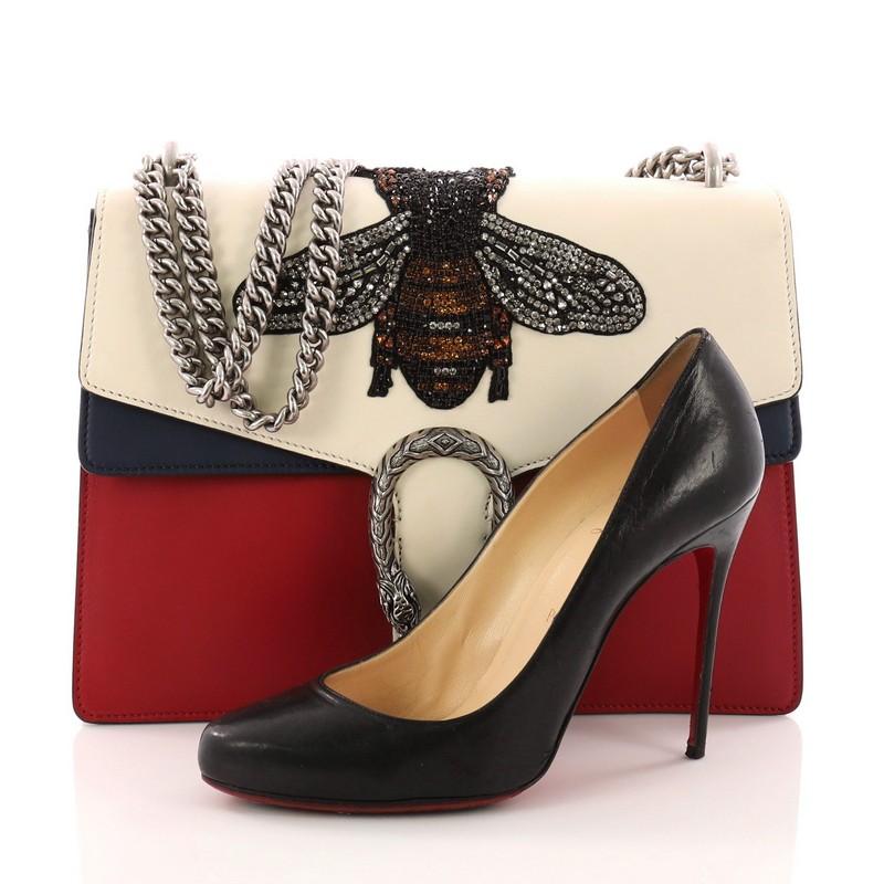 This authentic Gucci Dionysus Handbag Embellished Leather Medium named after the Greek God is a stunning piece created by celebrated designer Alessandro Michele. Crafted from white, red and blue embelished leather, this bag features chain link