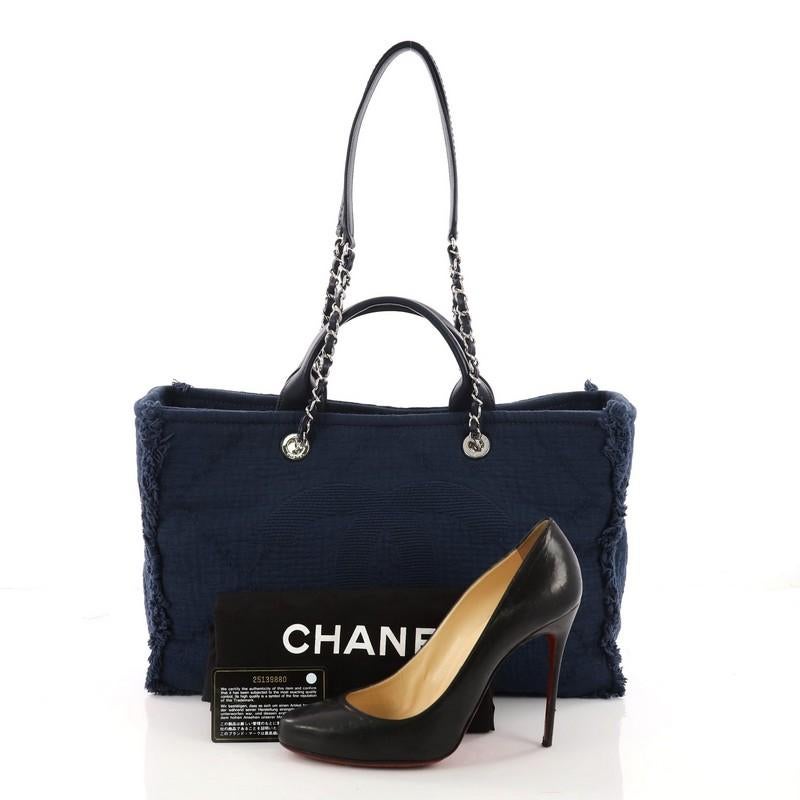 This authentic Chanel CC 2-Way Shopping Tote Fringe Quilted Canvas Large showcases a simple and elegant style made for everyday use. Constructed in blue fringe quilted canvas, this tote features dual leather handles, dual woven-in leather straps