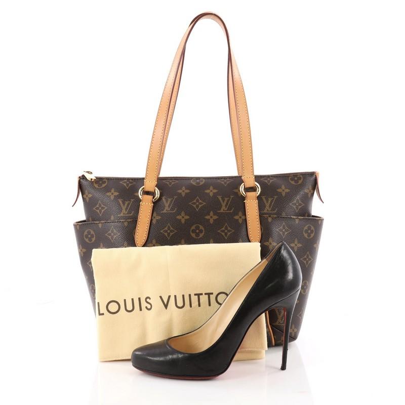 This authentic Louis Vuitton Totally Handbag Monogram Canvas PM is a chic and practical bag for everyday occasions. Crafted from Louis Vuitton's iconic monogram coated canvas, this simple tote features tall cowhide leather handles and trims, two