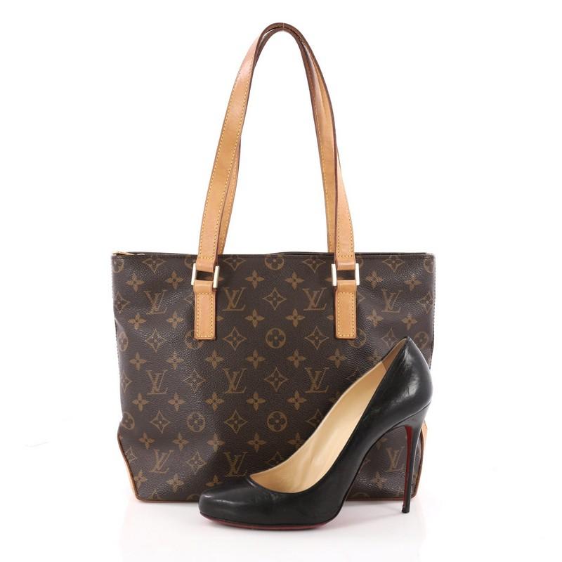 This authentic Louis Vuitton Cabas Piano Monogram Canvas is a practical and minimalist tote classic to the brand's design. Crafted with Louis Vuitton's iconic brown monogram coated canvas, this simple tote features tall cowhide leather handles and