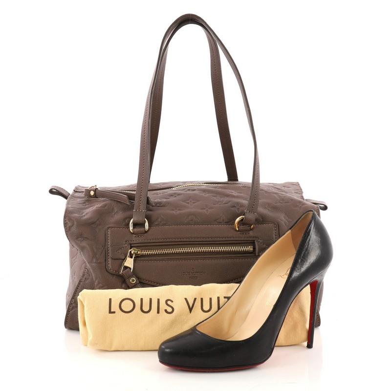 This authentic Louis Vuitton Inspiree Handbag Monogram Empreinte Leather is a bag with a unique and modern structure that would be a great addition to your collection. Crafted from dark taupe monogram empreinte leather, this fabulous bag features