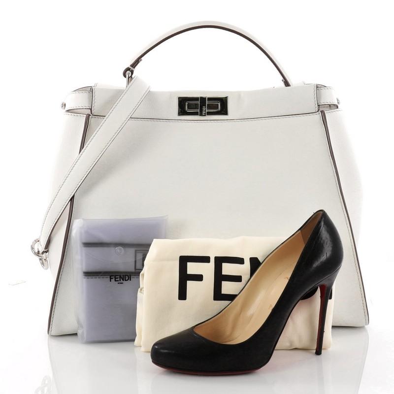 This authentic Fendi Peekaboo Monster Handbag Leather with Fur Interior Large is a stand-out piece updating classic Peekaboo style. Crafted from luxurious white leather, this stylish tote features its eye-catching yellow monster eye applique design,