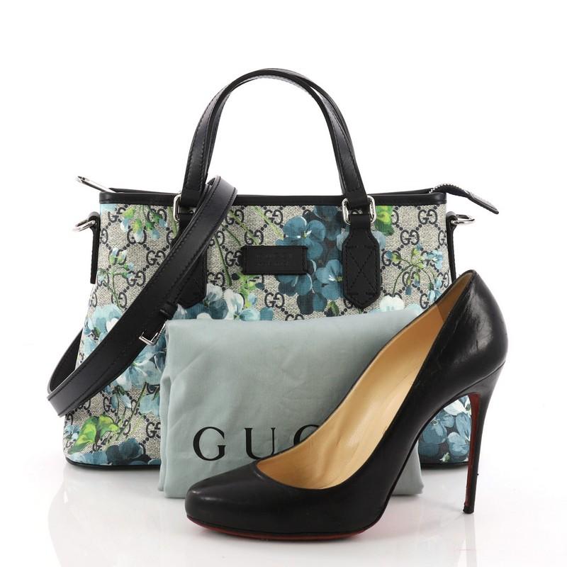 This authentic Gucci Convertible Tote Blooms Print GG Coated Canvas Small is your perfect everyday tote. Crafted in GG supreme coated canvas with blue blooms print overlay and leather trims, this stand-out tote features dual top handles, adjustable