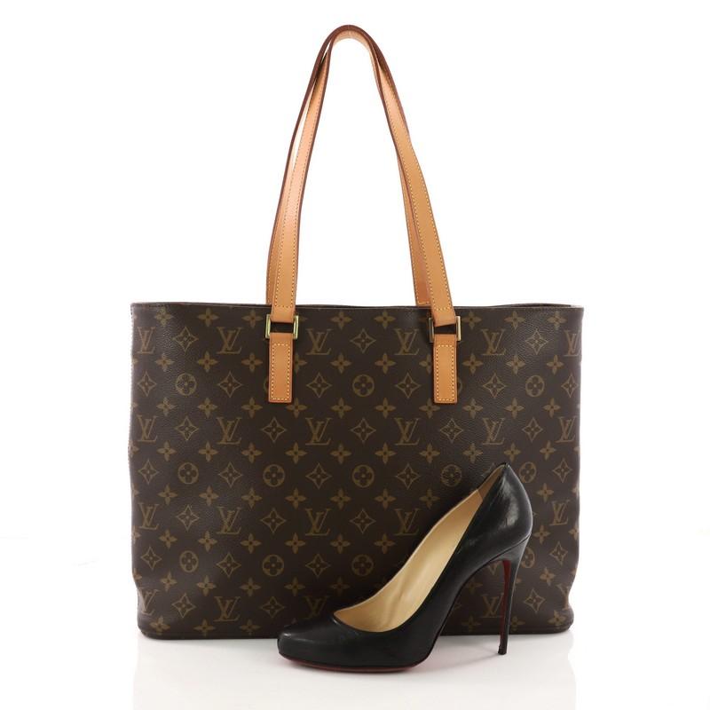 This authentic Louis Vuitton Luco Handbag Monogram Canvas is a classic tote that displays fashion and functionality all rolled into one. Crafted with the brand's iconic brown monogram coated canvas, this tote features dual flat leather handles, a