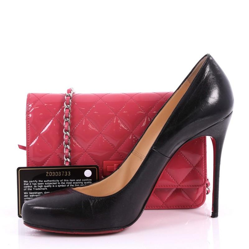 This authentic Chanel Reissue Wallet on Chain Quilted Patent adds a touch of glamour to any look with its pop of color. Crafted from dark pink diamond quilted patent leather, this petite bag features a decorative Chanel mademoiselle turn-lock on its