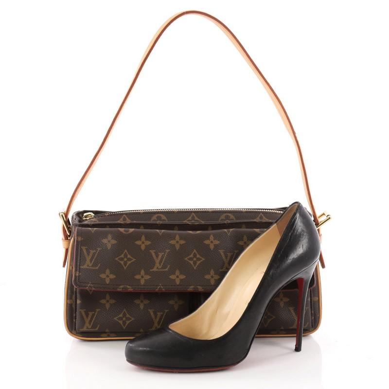 This authentic Louis Vuitton Viva Cite Handbag Monogram Canvas MM is a simple bag perfect for everyday looks. Crafted from the brand's classic brown monogram coated canvas, this casual shoulder bag features a single adjustable wide vachetta leather