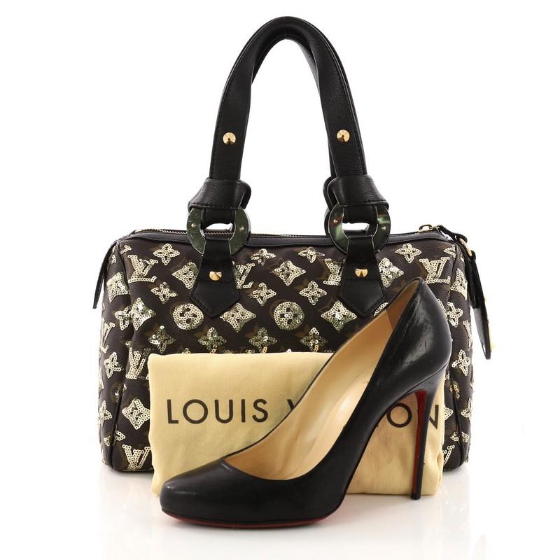 This authentic Louis Vuitton Speedy Handbag Limited Edition Monogram Eclipse Sequins 28 updates the iconic Speedy with an enchanting and luxurious version. Crafted in stunning brown monogram coated canvas with meticulous overlays of black sequins