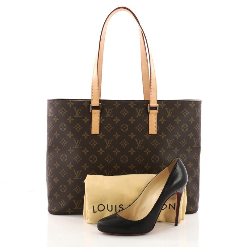 This authentic Louis Vuitton Luco Handbag Monogram Canvas is a classic tote that displays fashion and functionality all rolled into one. Crafted with the brand's iconic brown monogram coated canvas, this tote features dual flat leather handles, a