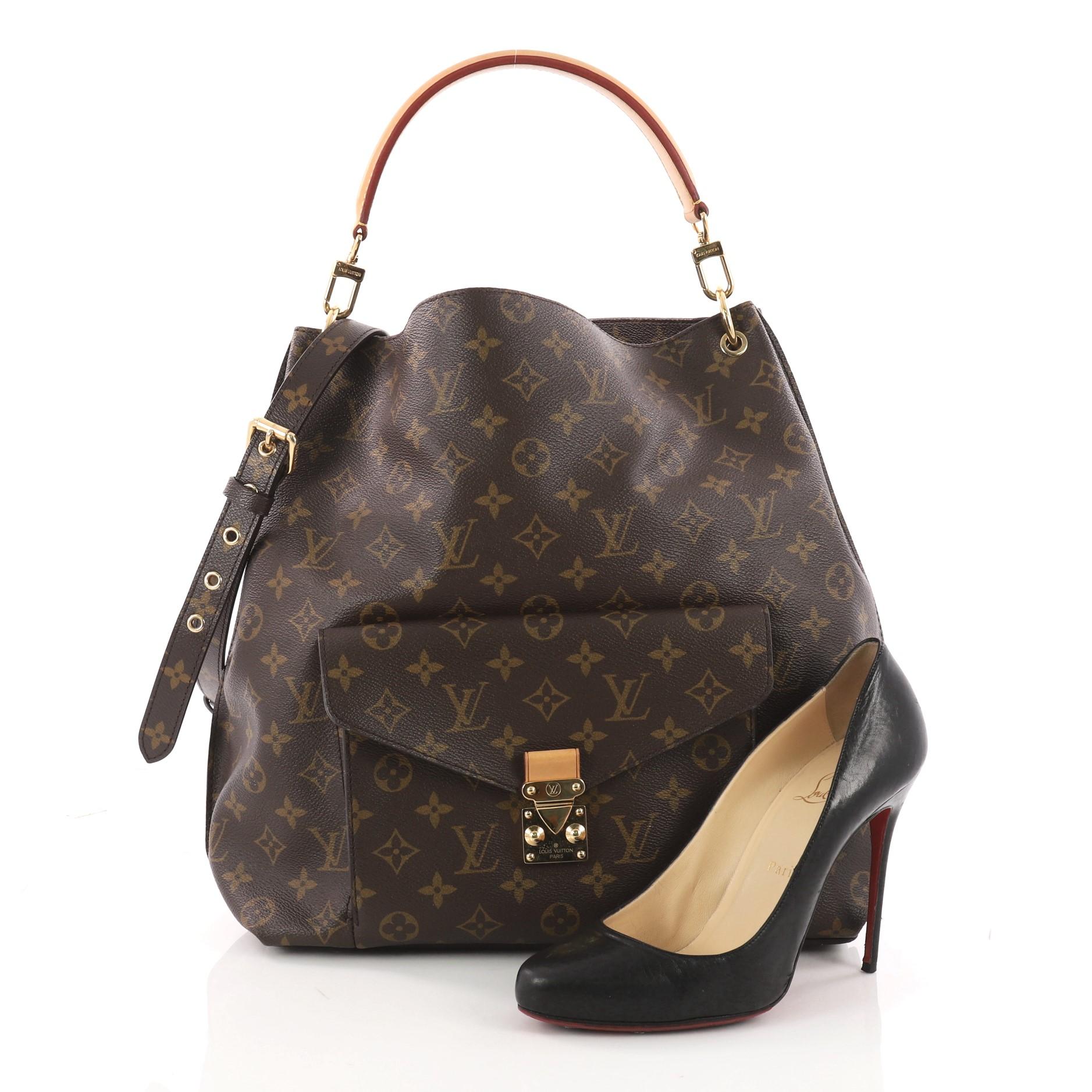 This authentic Louis Vuitton Metis Hobo Monogram Canvas epitomizes luxurious design and the brand's commitment to timeless sophistication with a modern twist. Crafted in iconic brown monogram coated canvas, this hobo features a front flap pocket