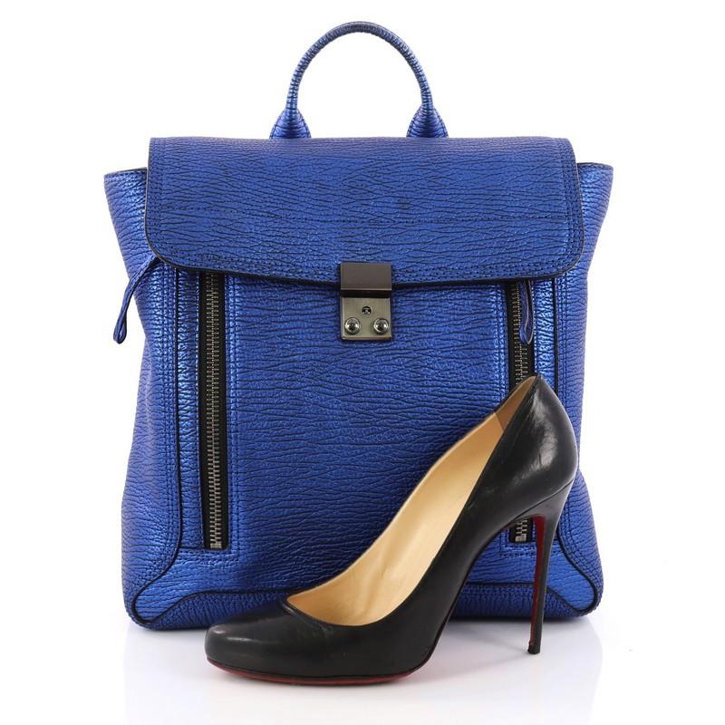 This authentic 3.1 Phillip Lim Pashli Backpack Leather combines a cool style and functionality for the modern woman. Crafted from blue metallic leather, this eye-catching, edgy backpack features two expandable zip gussets at the front, short top