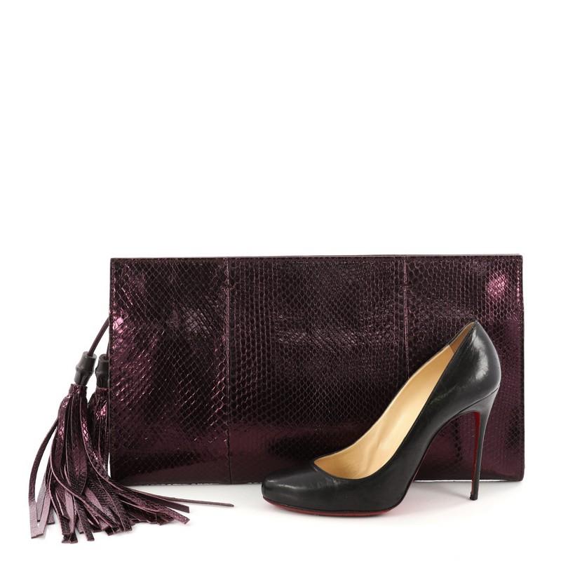 This authentic Gucci Nouveau Clutch with Tassels Python XL is a compact and convenient accessory perfect for everyday use. Crafted from genuine purple python skin, this clutch features black lacquered bamboo details, double tassel with bamboo