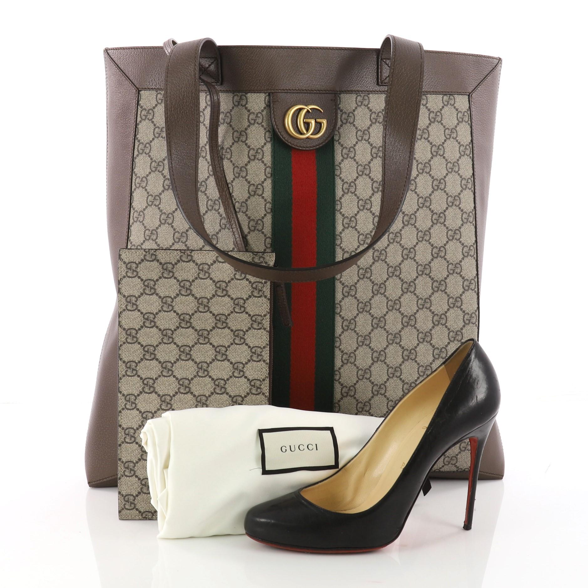 This authentic Gucci Ophidia Soft Open Tote GG Coated Canvas Large is a perfect new bag to carry everyday. Crafted in taupe GG supreme coated canvas, this chic bag features dual flat leather handles, signature green and red web detailing, GG logo