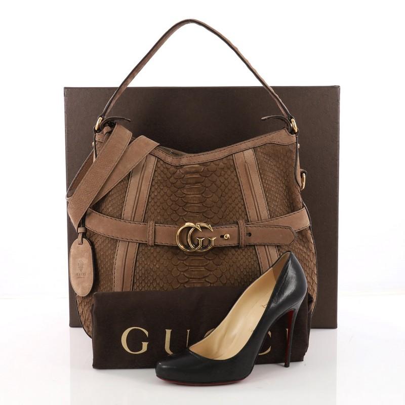 This authentic Gucci GG Running Hobo Python Medium is a chic and sophisticated bag for everyday use. Crafted from genuine brown python skin with brown nubuck trims, this iconic bag features flat leather shoulder strap, GG logo at front and gold-tone