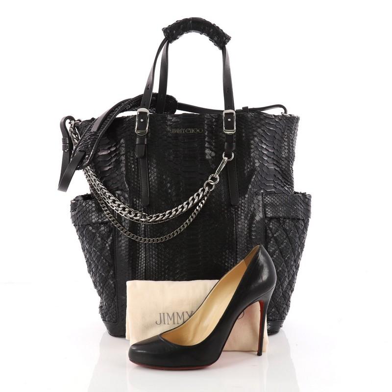 This authentic Jimmy Choo Blare Convertible Tote Python is an easy to wear slouchy tote that displays more casual, yet modern design ideal for your everyday looks. Crafted from genuine black python skin this tote features dual top handles with