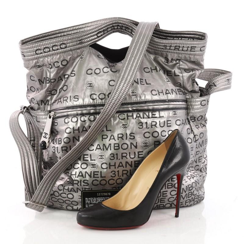 This authentic Chanel Unlimited Messenger Bag Nylon Large is a chic and stylish bag. Crafted in grey printed nylon, this bag features dual-flat nylon handles, printed Chanel Paris 31 Rue Cambon all over, exterior zip pocket and silver-tone hardware