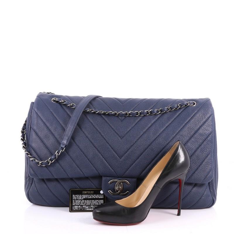 This authentic Chanel Airlines CC Flap Bag Chevron Calfskin XXL is an oversized travel beauty made for all Chanel lovers. Crafted in navy calfskin leather in chevron quilted design, this larger-than-life flap bag features a woven-in leather chain