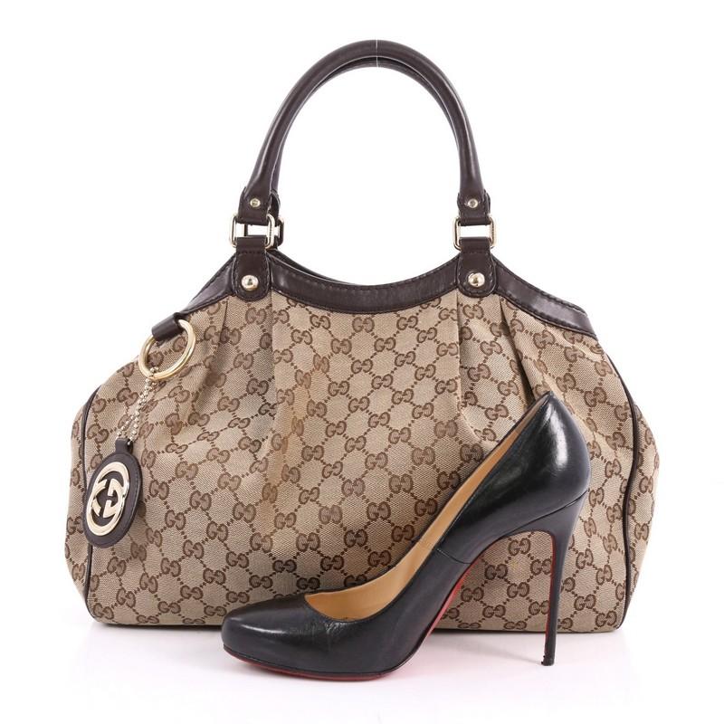 This authentic Gucci Sukey Tote GG Canvas Medium is perfect for any casual or sophisticated outfit. Constructed from Gucci's brown GG monogram canvas with leather trims, this roomy tote features dual-rolled leather handles that sit comfortably on