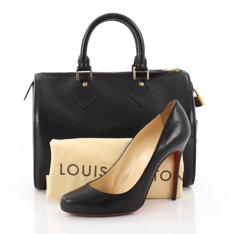 This authentic Louis Vuitton Speedy Handbag Epi Leather 25 is a timeless favorite of many. Crafted in black epi leather, this bag features dual-rolled handles, subtle stamped LV logo, exterior side slip pocket and gold-tone hardware accents. Its top