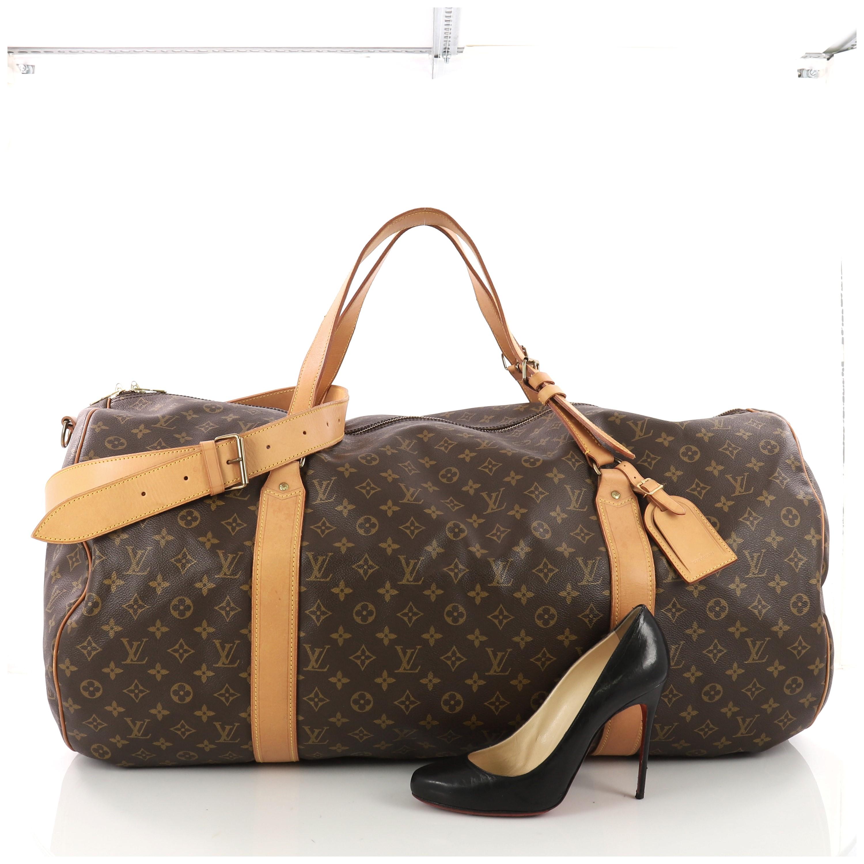 This authentic Louis Vuitton Sac Polochon Handbag Monogram Canvas 65 is the perfect purchase for a weekend trip, and can be effortlessly paired with any outfit from casual to formal. Crafted with traditional Louis Vuitton brown monogram coated