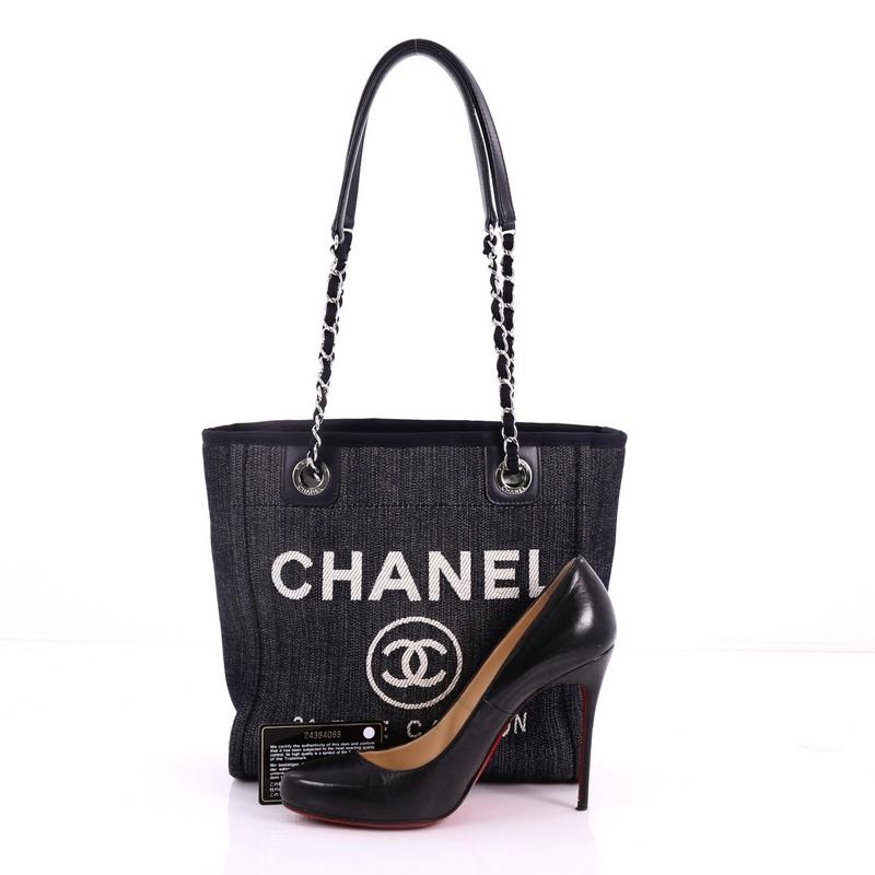 This authentic Chanel North South Deauville Chain Tote Denim Small embodies a casual-chic style made for any fashionista. Crafted in navy denim, this stylish tote features woven-in canvas chain link straps, embroidered CC logo with Chanel's famous
