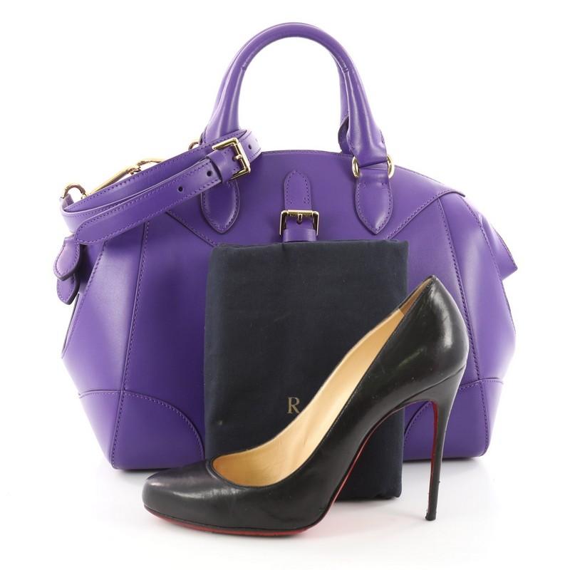 This authentic Ralph Lauren Collection Stirrup Bedford Handbag Leather Small is a fresh and stylish bag perfect for your wardrobe. Crafted from purple leather, this handbag features dual-rolled leather handle, stirrup buckle detail and gold-tone