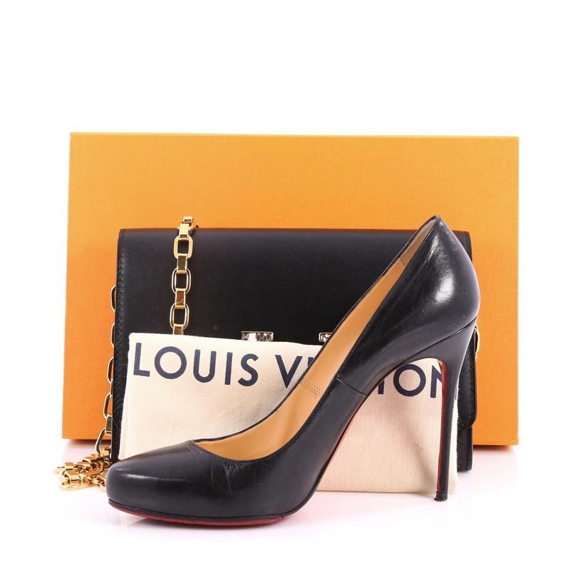 This authentic Louis Vuitton Chain Louise Clutch Leather with Python GM is perfect for day to night looks. Crafted in black leather, this modern yet feminine chain clutch features an oversized python LV flip-lock clasp closure in sleek design,