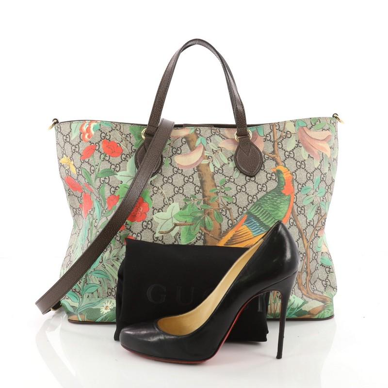 This authentic Gucci Convertible Soft Tote Tian Print GG Coated Canvas Medium is a chic tote inspired by lauded designer Alessandro Michele's homage to 18th Century Eastern tropical tapestries. Crafted from brown GG supreme coated canvas overlaid