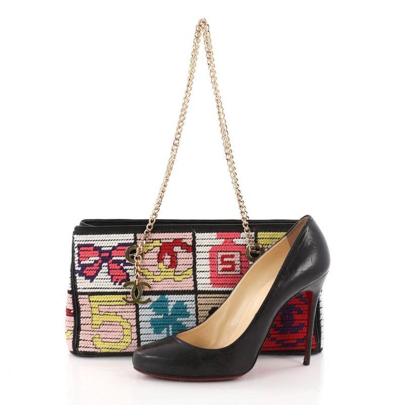 This authentic Chanel Vintage Patchwork Icons Chain Tote Crochet Tweed Small is a rare and unique piece and an exceptional addition to any collection. Crafted in multicolor Crochet tweed with classic Chanel icons, this chic bag features dual-chain