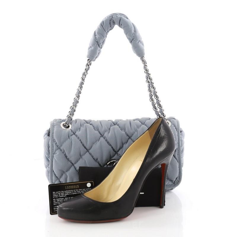 This authentic Chanel Bubble Flap Bag Quilted Nylon Medium is sure to compliment just about every casual outfit. Crafted in blue striped quilted nylon, this flap bag features a woven-in nylon chain link strap, Chanel's CC logo at the front and