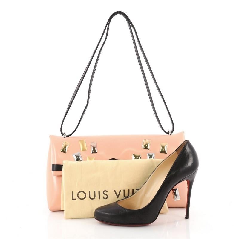 This authentic Louis Vuitton Sac Triangle Handbag Embellished Glazed Calfskin PM is a sophisticated tote that is designed to be beautiful and practical. Crafted in pink embellished glazed calfskin, this stylish bag features a leather shoulder strap,