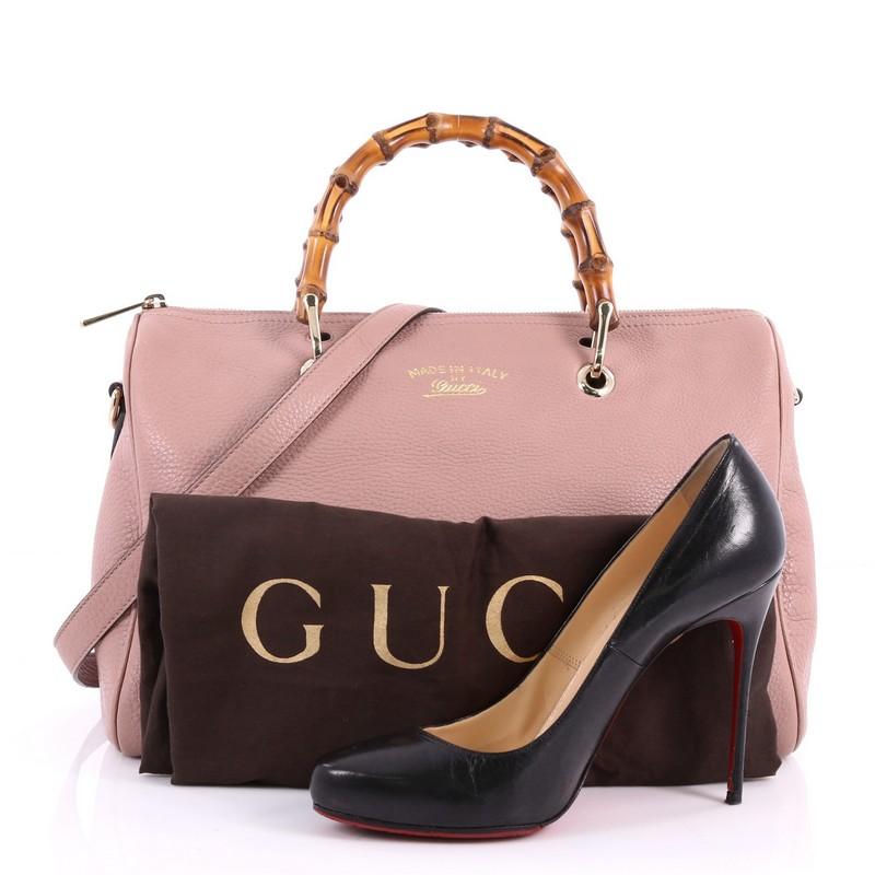 This authentic Gucci Bamboo Shopper Boston Bag Leather Medium is a classic must have. Crafted from pink leather, this simple yet stylish bag features Gucci's signature sturdy bamboo handles, protective base studs, stamped logo at the front, and