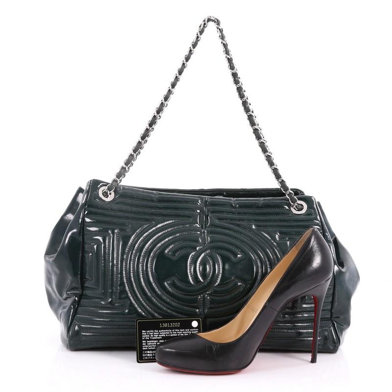 This authentic Chanel Coco Ming Chain Tote Quilted PVC Medium is an exquisite tote for day or evening wear. Crafted in green quilted PVC, this chic bag features woven-in leather chain straps, front and center Chanel CC quilted logo and gunmetal-tone