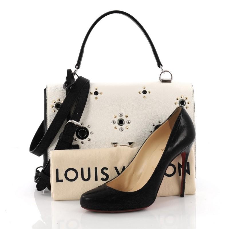 This authentic Louis Vuitton Lockme II Handbag Embellished Leather is a must-have signature city bag made for the modern woman. Crafted from white and black embellished leather, this chic bag features a single loop leather handle, over-scale LV