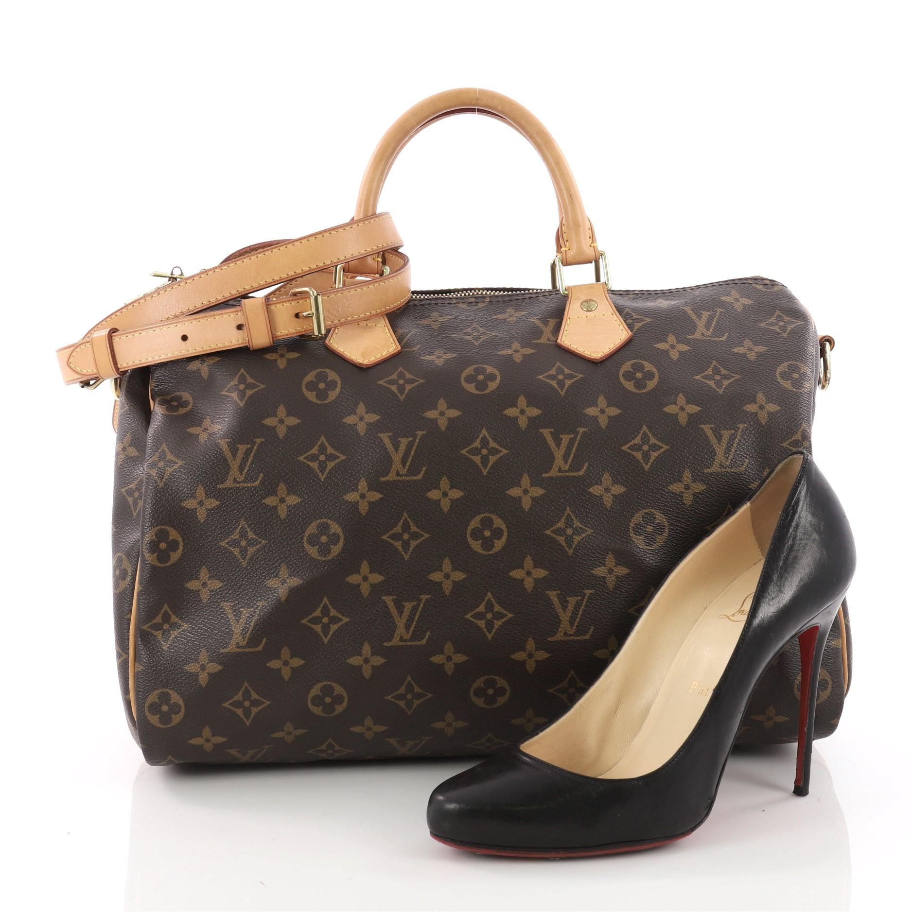 This authentic Louis Vuitton Speedy Bandouliere Bag Monogram Canvas 35 is a versatile and classic accessory made for everyday use. Crafted from Louis Vuitton's brown monogram coated canvas, this updated Speedy features dual-rolled vachetta leather