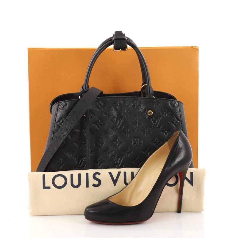This authentic Louis Vuitton Montaigne Handbag Monogram Empreinte Leather MM is as sophisticated as it is sturdy. Crafted in navy monogram empreinte leather, this luxurious and refined bag features dual-rolled leather handles, protective base studs