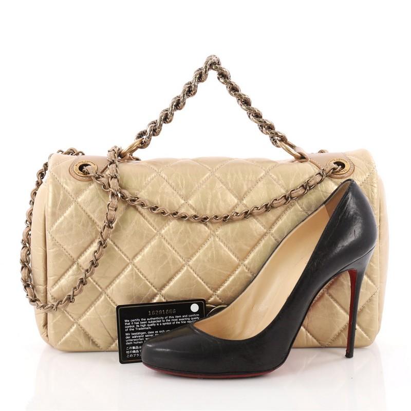 This authentic Chanel Pondichery Flap Bag Quilted Aged Calfskin Medium presented in the brand's 2012 Paris Bombay Collection is an exquisite accessory inspired by India. Crafted from gold aged calfskin leather with diamond quilting, this impressive