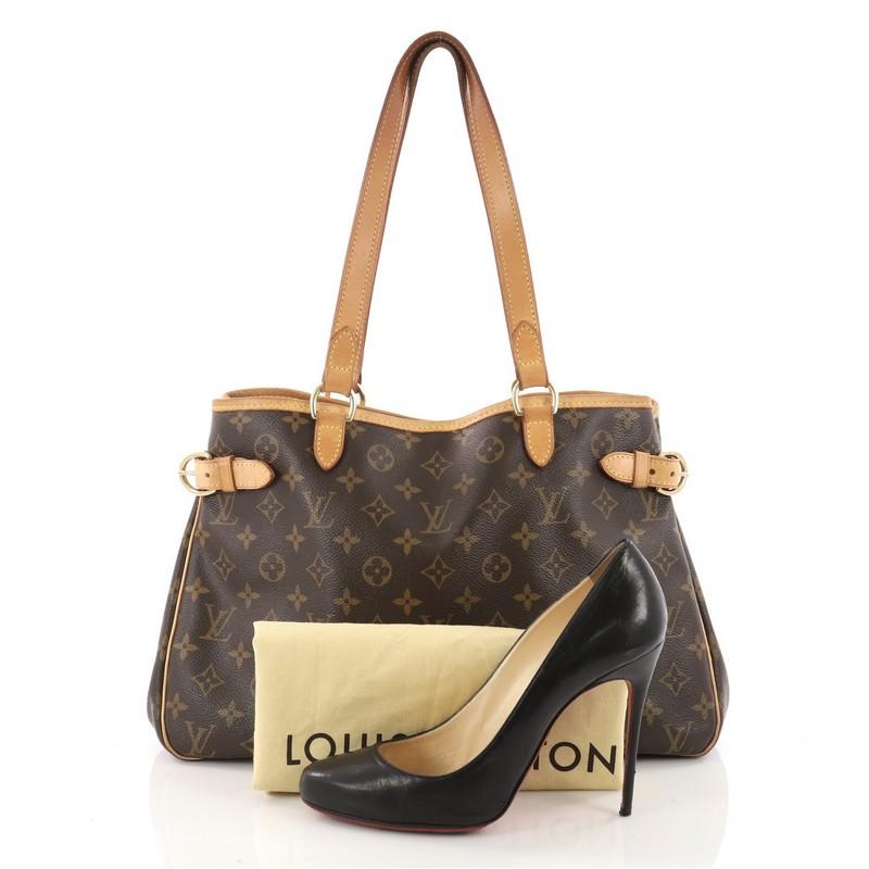 This authentic Louis Vuitton Batignolles Handbag Monogram Canvas Horizontal is a classic accessory made for casual wear. Crafted from Louis Vuitton's iconic brown monogram coated canvas, this functional tote features vachetta leather shoulder straps