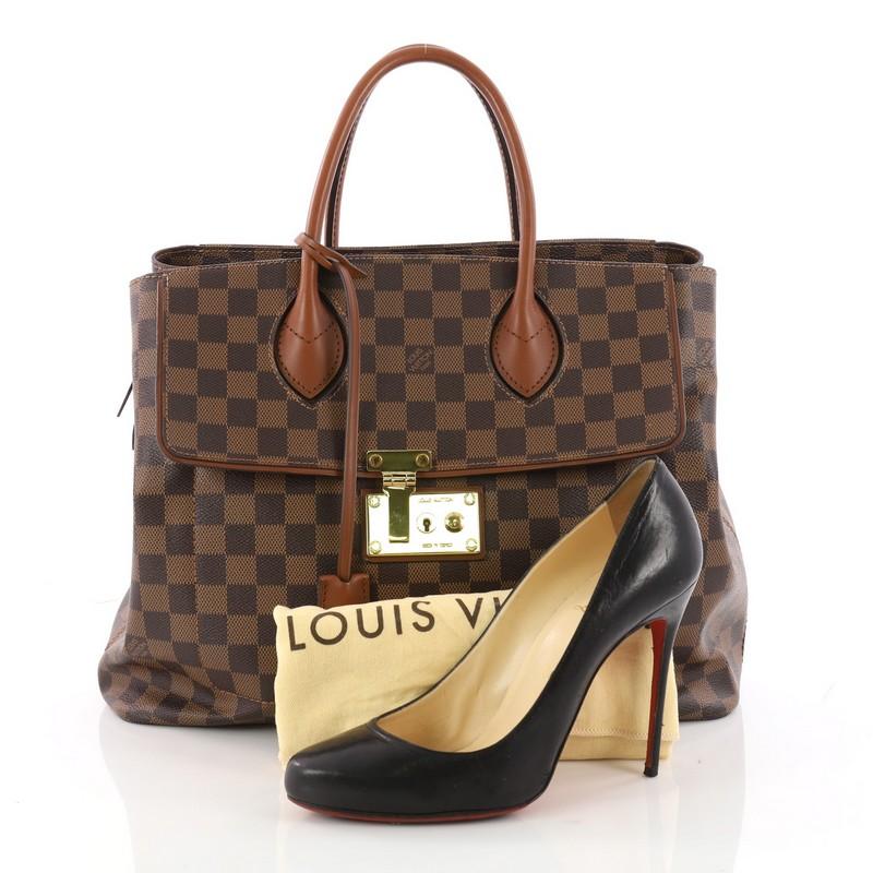 This authentic Louis Vuitton Ascot Handbag Damier is sophisticated and functional made for everyday use or light traveling. Crafted from damier ebene with nomade calf leather trims, this structured tote features dual-rolled leather handles, exterior